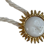 Image of a cord necklace with a sun charm. it's against a white background. the purpose of this image is to highlight the necklace by Pajarolimon jewelry because it's for sale at EVAMAIA Boutique in Studio City, CA.