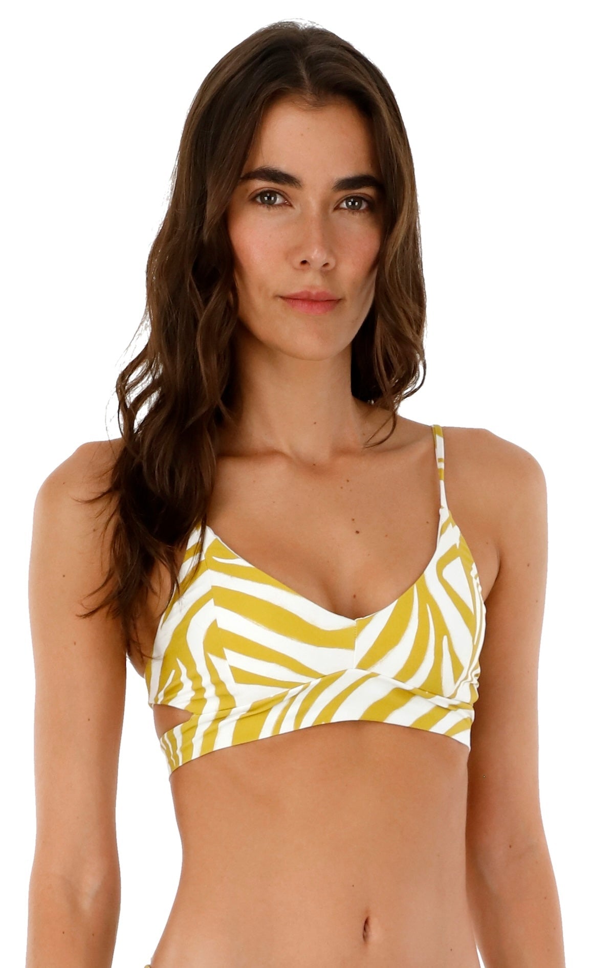 Woman wearing a bikini top with white and yellow animal print. She's standing against a white background. The purpose of this image is to highlight the swimsuit.