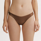 Brown bikini bottom worn by a person on a white background.