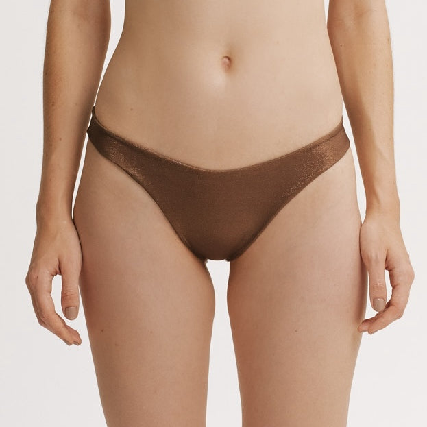 Brown bikini bottom worn by a person on a white background.