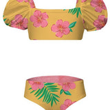 Yellow bikini top and bottom with pink floral and green leaf pattern on a white background