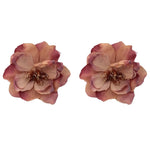 Pair of pink flower-shaped earrings on a white background
