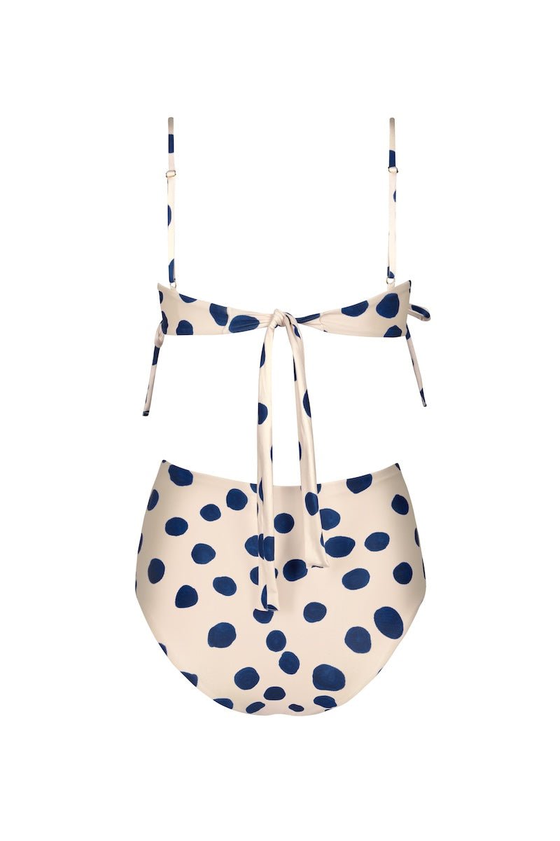Back of a white swimsuit set with blue polka dots. It's on a white background. The purpose of this image is to highlight the swimsuit because it's for sale at EVAMAIA Boutique.