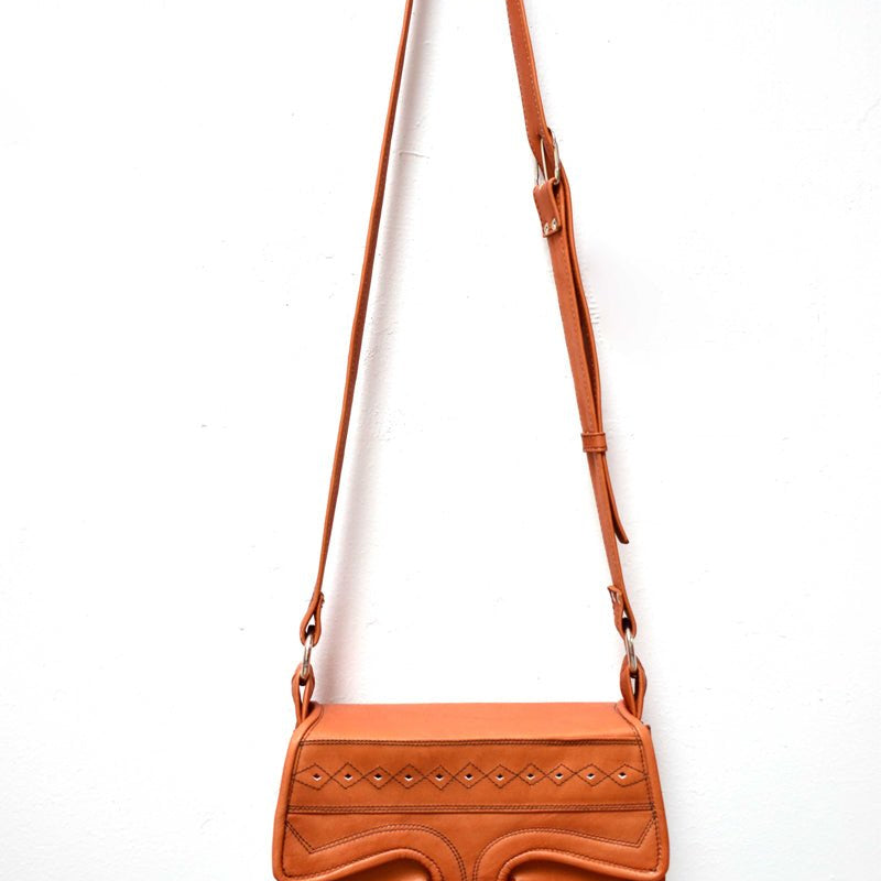 A crossbody saddle leather bag with multiple pockets.
