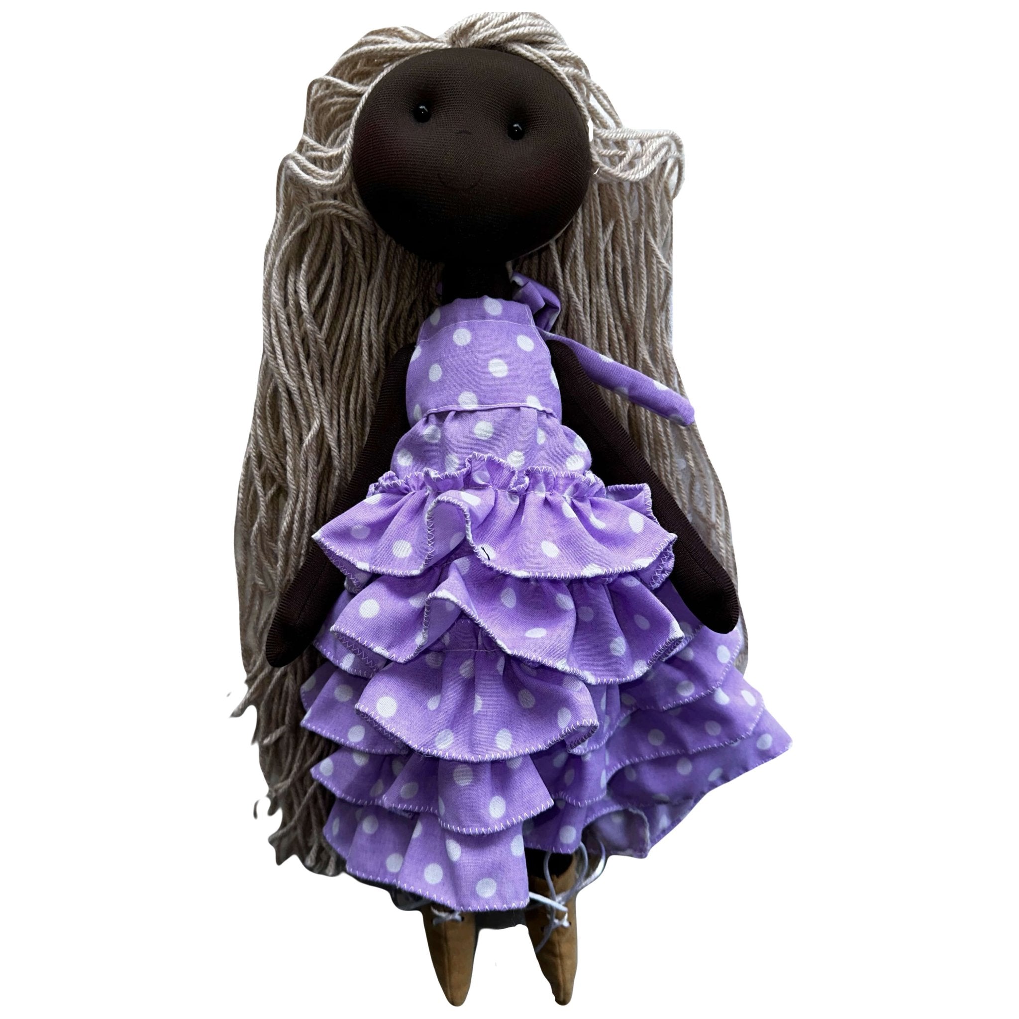 Handmade rag doll from Colombia. She is a ballerina with cute purple polka dot dress with ruffles. She has blonde braids. 