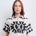 Model wearing a stylish black and white abstract print shirt made from high-quality polyester with a linen-like feel