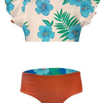 Two-piece swimsuit with floral top and orange bottom on a white background
