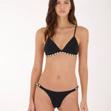 A woman modeling a black triangle bikini with pearl embellishments along the underbust band and waistband, set against a plain white studio background.