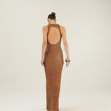 Woman wearing a brown crochet open-back dress on a white background.