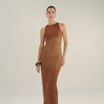 Woman wearing a brown crochet dress on a white background.
