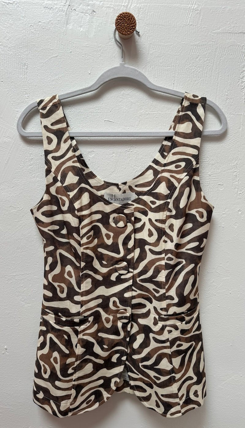 Image of a brown vest hanging on a hanger at a boutique. It's against a greyish white wall. 