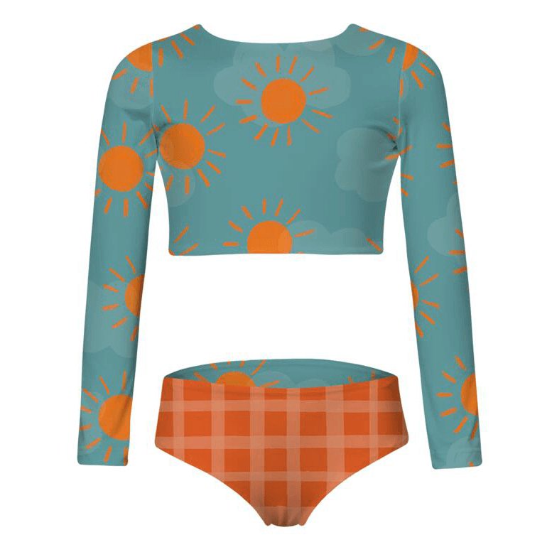 Long sleeve two piece swimsuit for girls. Adorable sun and cloud pattern for the top, and orange plaid bikini bottom. The swimsuit is shown against a white background.