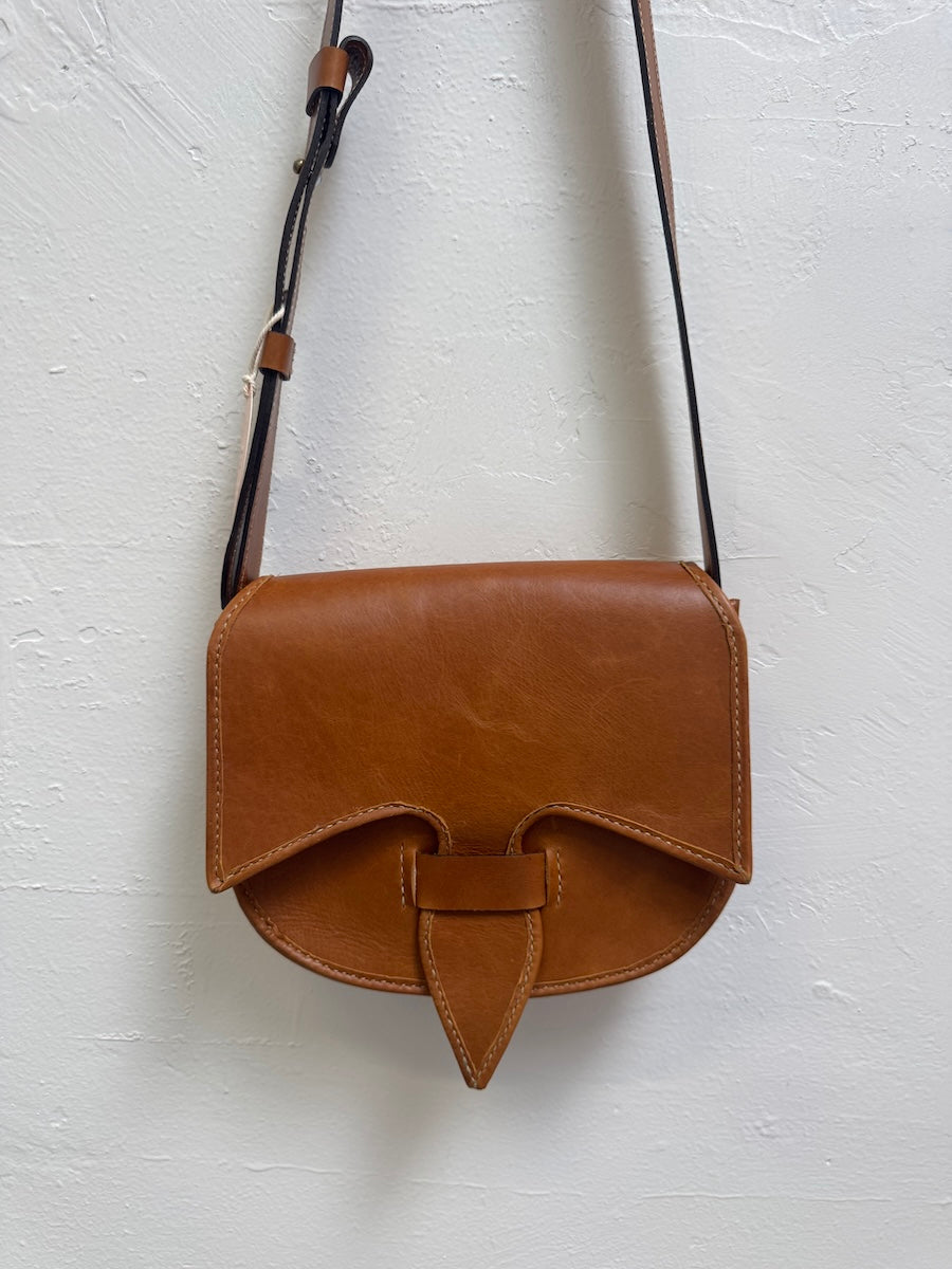 Brown leather crossbody bag on a light gray background