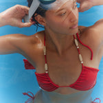 Woman in a red bikini with snorkeling gear on a blue background