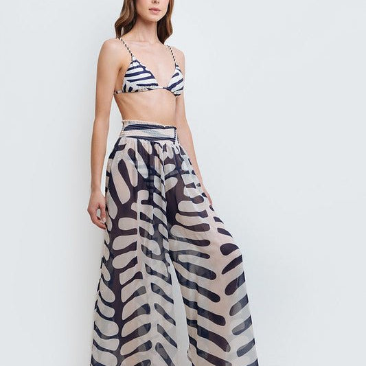 Woman wearing Kate Sheer Pants by Mar de Lua with elastic waistband and modern pattern. Made in Colombia, available at EVAMAIA Boutique, Studio City, Los Angeles, CA.