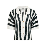 Black and white striped shirt with gold buttons on a white background.
