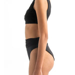 Side image of a model wearing the Leonor Bikini top and the Leo bikini bottom by Encantadore Swimwear.
