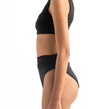 Side image of a model wearing the Leonor Bikini top and the Leo bikini bottom by Encantadore Swimwear.