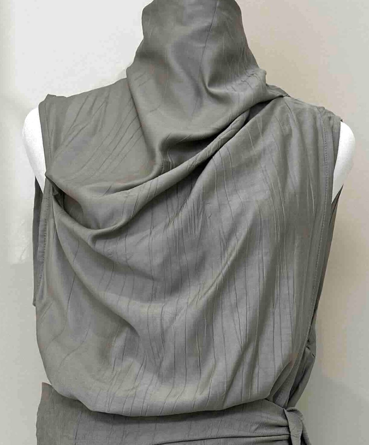 A gray draped sleeveless top or dress displayed on a white mannequin torso against a plain light background.
