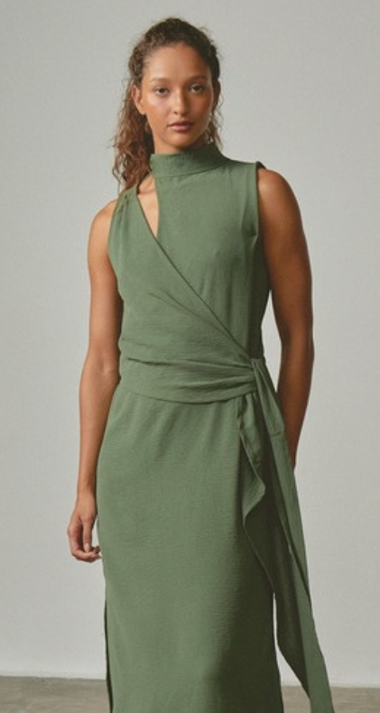 Woman wearing a green dress against a plain background