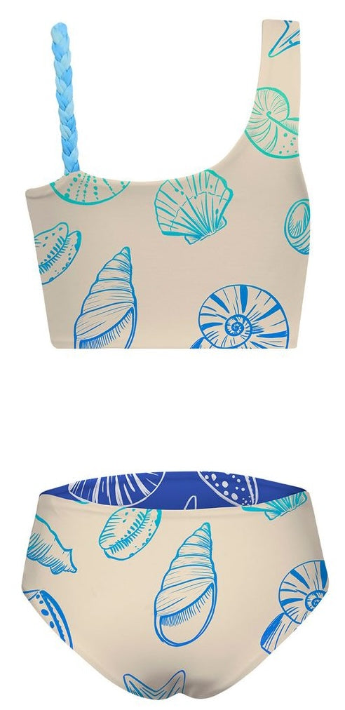Two-piece swimsuit with shell pattern on a beige background