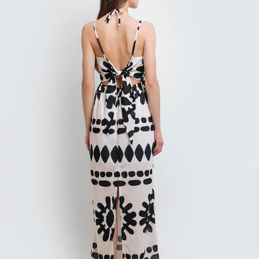 Model wearing a stylish black and white abstract print dress made from high-quality polyester with a linen-like feel