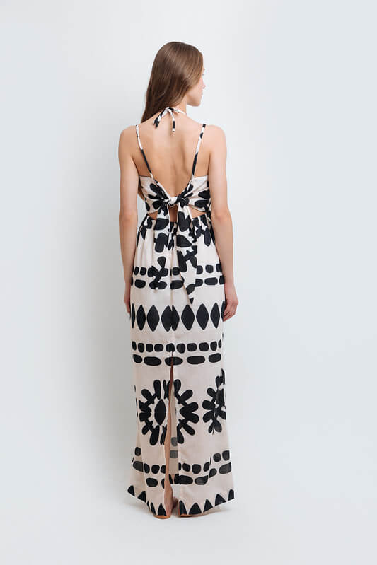 Model wearing a stylish black and white abstract print dress made from high-quality polyester with a linen-like feel