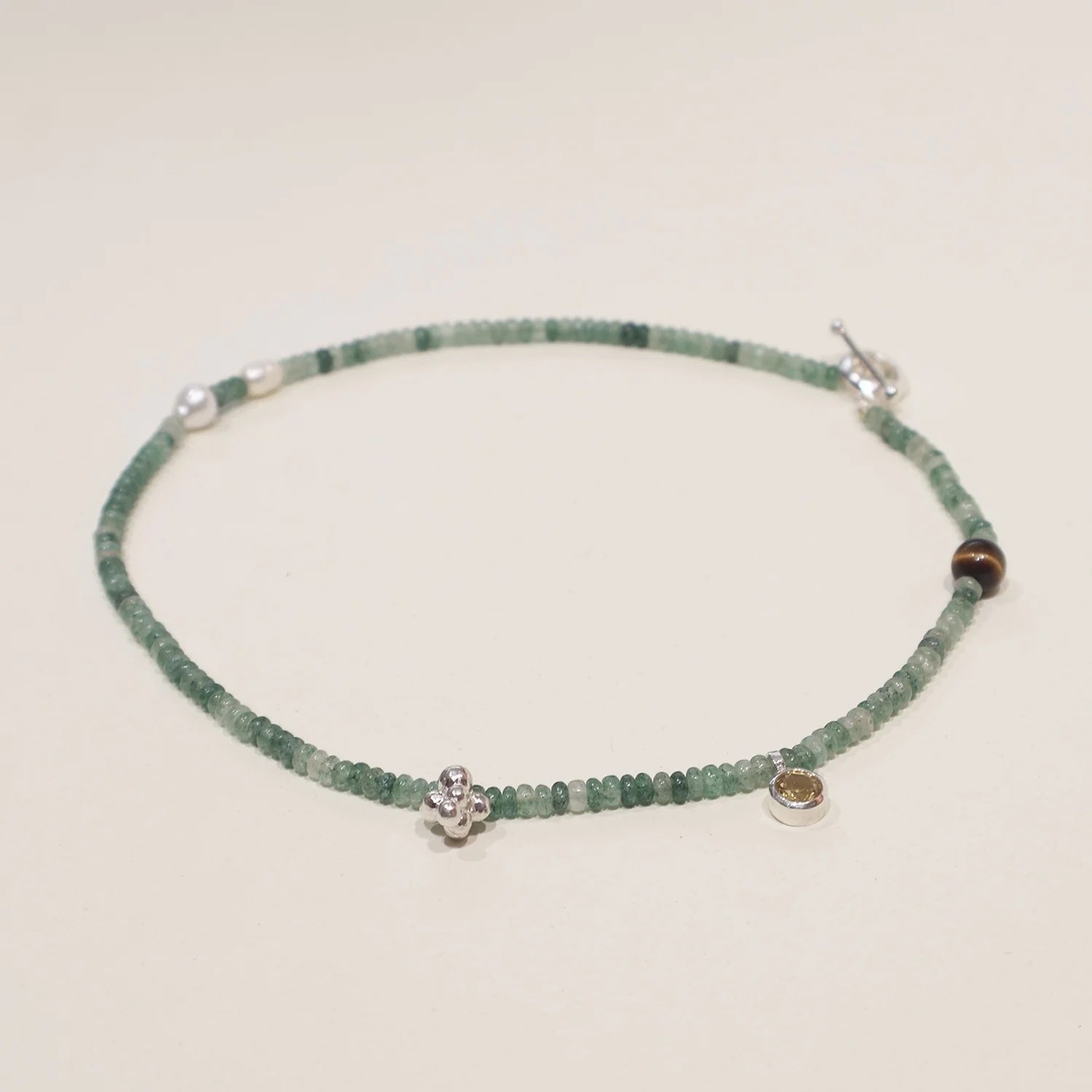 Green quartz beaded necklace with citrine, pearl, and tiger's eye accents in sterling silver