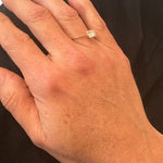 Close up image of a woman's hand wearing a dainty gold ring with a raw quartz stone on it. The purpose of this image is to highlight the ring because it is for sale at EVAMAIA boutique in Studio City, CA and online.