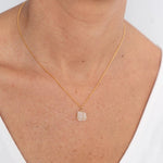 Close up image of a woman wearing a gold necklace with a moonstone charm. The purpose of this image is to highlight the necklace by Wish Jewelry because it's sold at EVAMAIA boutique in Studio City, CA.