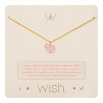 Image of a gold necklace with a rose quartz charm. It's on its packaging. The purpose of this image is to highlight the necklace by Wish Jewelry because it's sold at EVAMAIA boutique in Studio City, CA.