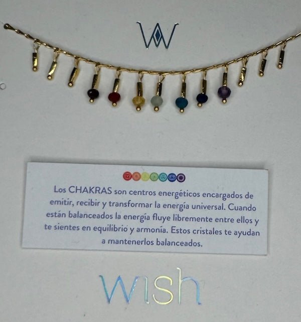 Close up image of a dainty necklace with 7 stones representing the chakras. The purpose of this image is to highlight the necklace, which we sell at EVAMIA boutique in Studio City, CA and online.