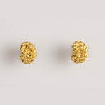 Image of gold earrings with a knot design. The purpose of this image is to highlight the earrings by Alma Jewelry. 