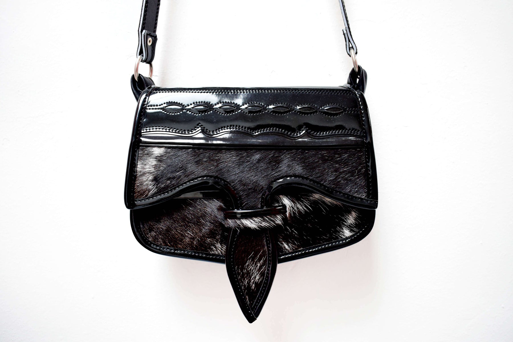 Crossbody saddle bag with two toned leather and texture. 