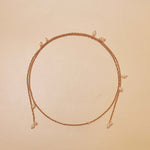 Necklace with small pearls on a beige background