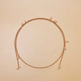 Necklace with small pearls on a beige background