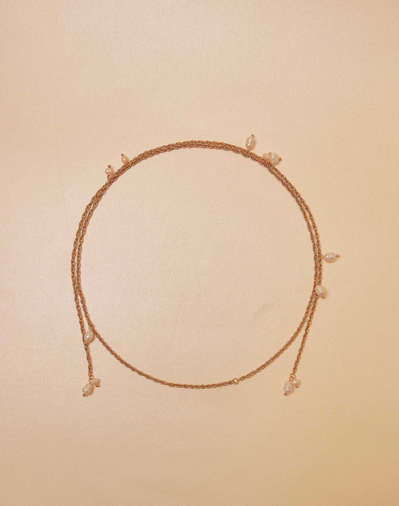 Necklace with small pearls on a beige background