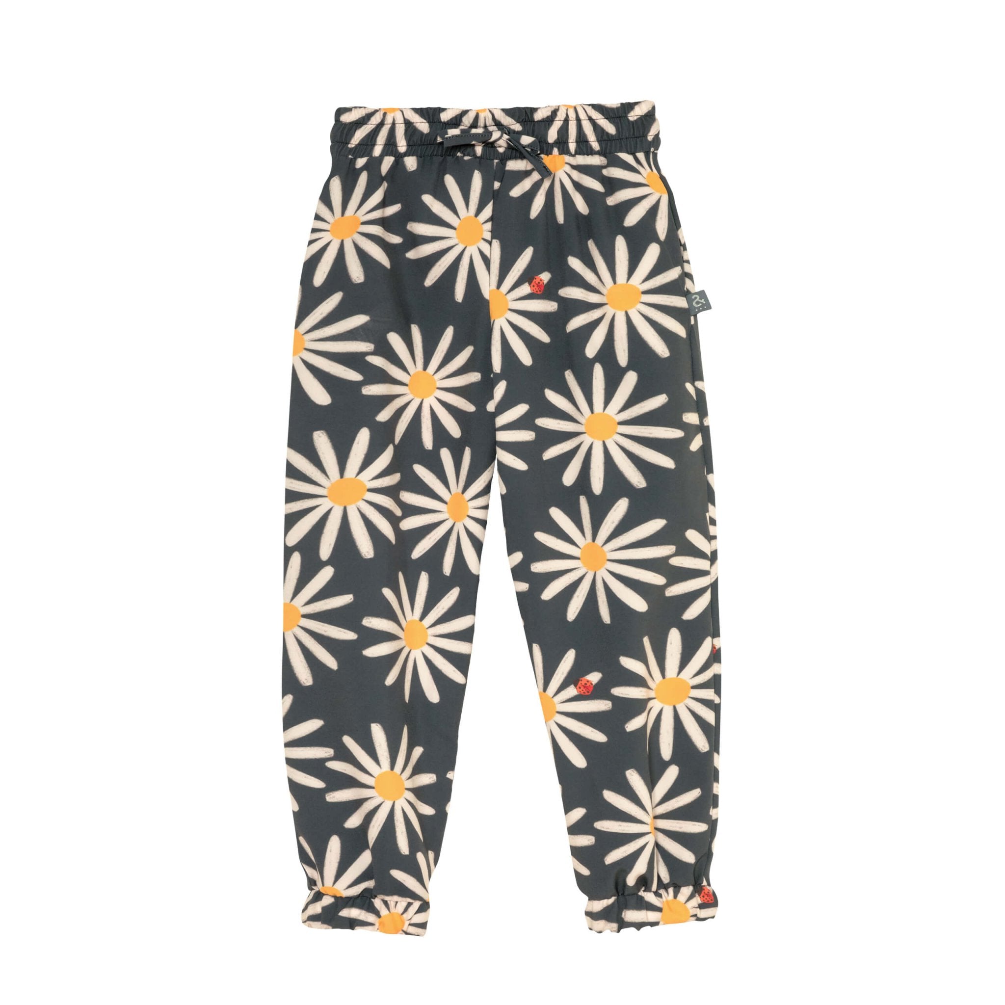 Adorable grey sunflower printed pants for girls. It has a drawstring waist and cinched legs. Also ittle ladybug details. The pants are shown over a white background.