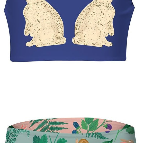 Two-piece girl's swimsuit with rabbit design on top and nature-themed bottom on a white background.