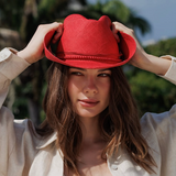 Woman wearing a red hat with a blurred natural background