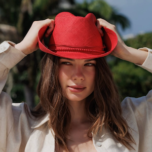 Woman wearing a red hat with a blurred natural background