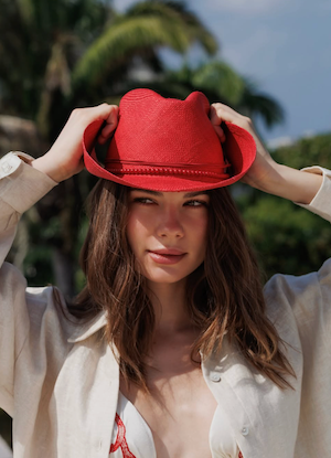 Woman wearing a red hat with a blurred natural background