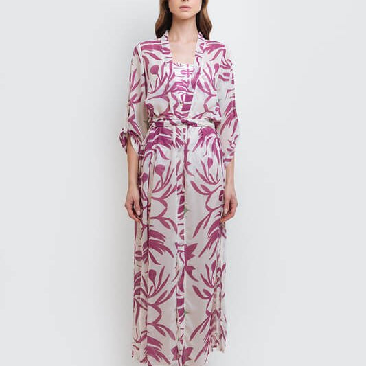 Image of a woman wearing a white and pink semi sheer kimono. The purpose of this image is to highlight the clothing because it's available for sale at EVAMAIA boutique in Studio City, CA.