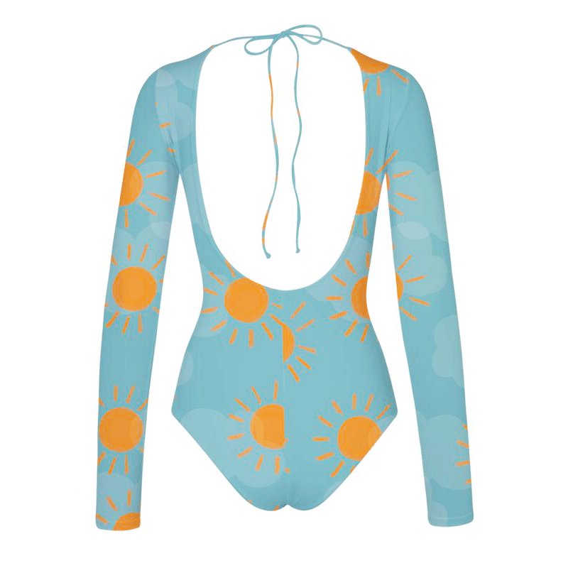 The back of the sun longsleeve one piece bikini. It is a sky blue swimsuit with a sun and cloud pattern all over. It has a thin neck tie along with a deep back cutout. The bikini is over a white background.