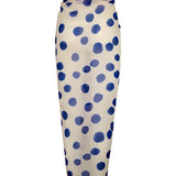 Image of a white sarong with blue polka dots. It's tied as it would be on a body. It's against a white background. The purpose of this image is to highlight the sarong, which is on sale at EVAMAIA boutique in Studio City.
