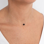  Image of a woman wearing a thin thread with a black tourmaline stone in the center as a necklace. The purpose of this image is to highlight the product (a threaded necklace and bracelet) because it is for sale at EVAMAIA boutique in Studio City, CA and online.