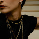 Woman wearing reclaimed sterling silver mini hoops with sphere trim and many necklaces, handcrafted in Bogotá, Colombia