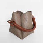 Image of the Tulip Baletti leather handbag in grey and camel. It's behind a white background. The purpose of the image is to highlight the bag because it is for sale at EVAMAIA boutique in Studio City, CA and online.