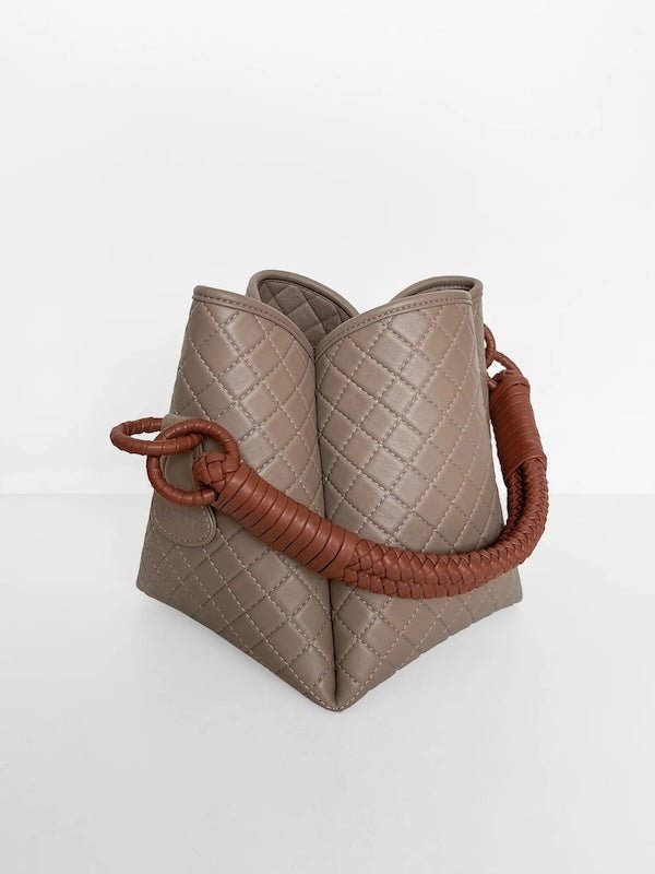 Image of the Tulip Baletti leather handbag in grey and camel. It's behind a white background. The purpose of the image is to highlight the bag because it is for sale at EVAMAIA boutique in Studio City, CA and online.