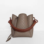 Image of the Tulip Baletti leather handbag in grey and camel. It's behind a white background. The purpose of the image is to highlight the bag because it is for sale at EVAMAIA boutique in Studio City, CA and online.